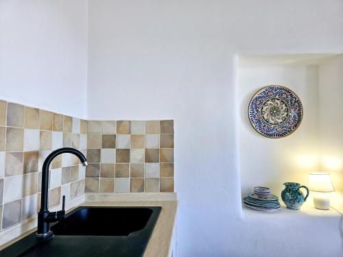 a kitchen with a sink and a plate on the wall at Villa Margot in Lipari