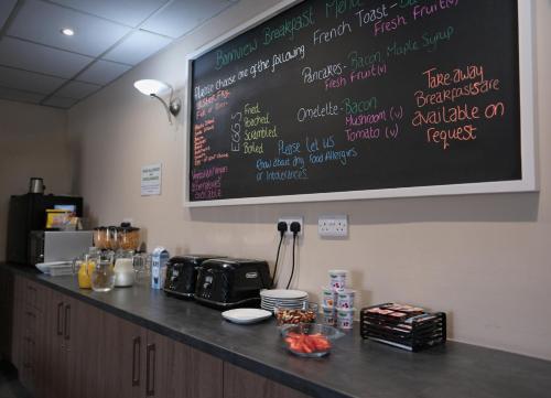 a chalkboard on the wall above a counter in a kitchen at Bannview Bed & Breakfast in Portadown