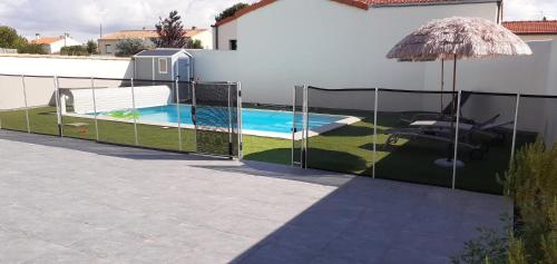 une clôture autour d'une piscine dans une arrière-cour dans l'établissement Appartement léonard, à Châtelaillon-Plage