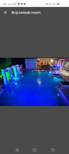 a picture of a swimming pool with blue lights at Braj samode resort in Sāmod