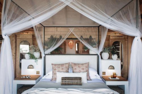 a bedroom with a bed with a canopy at Lovango Resort and Beach Club in Cruz Bay