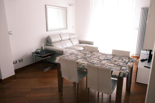 a living room with a table and a couch at Elegant Apartment in Santa by PortofinoVacanze in Santa Margherita Ligure