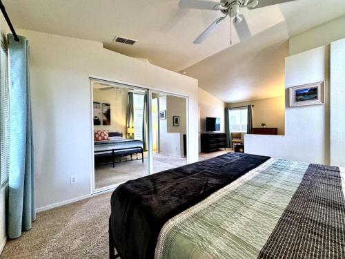 a bedroom with a bed with a ceiling fan at King Bed Retreat, Pet-Friendly, Rancho Cordova in Rancho Cordova