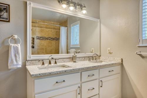 a bathroom with two sinks and a large mirror at Tranquility Base - Family Fun Modern Farm House in Dalton Gardens