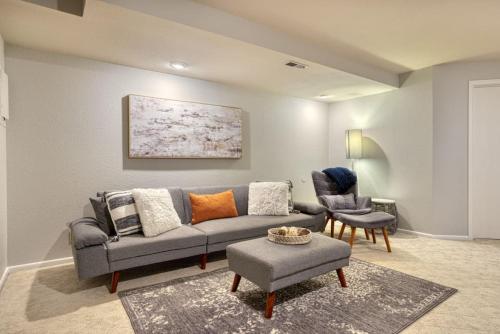 a living room with a couch and a chair at Tranquility Base - Family Fun Modern Farm House in Dalton Gardens
