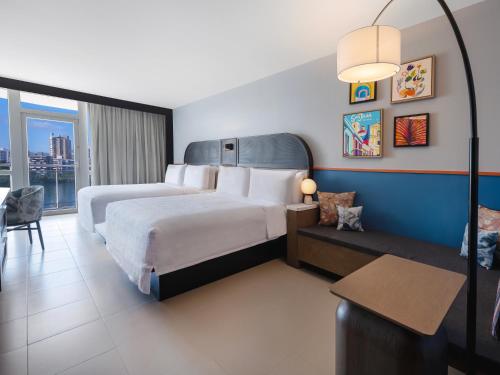 a hotel room with a bed and a couch at Hilton Garden Inn San Juan Condado in San Juan