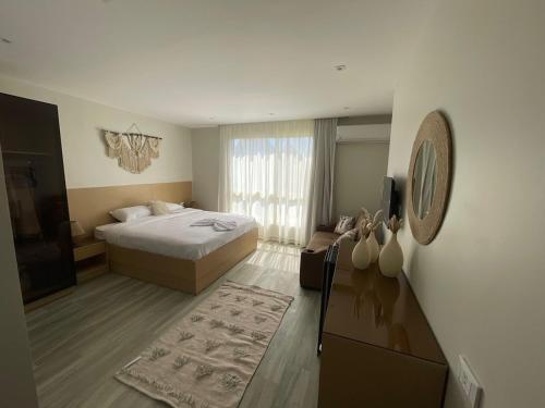 a hotel room with a bed and a television at Diyar Pyramids Inn in Cairo