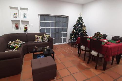 a living room with a christmas tree and a table at Casa campestre con las comodidades de la ciudad in Jamundí