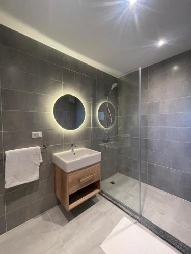 a bathroom with a sink and a shower at Diyar Pyramids Inn in Cairo