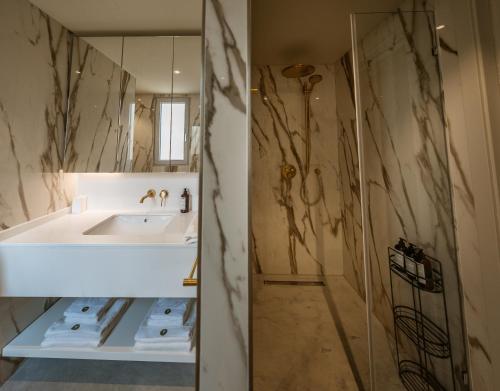 a bathroom with a sink and a mirror at Trabuxu Boutique Living in Valletta