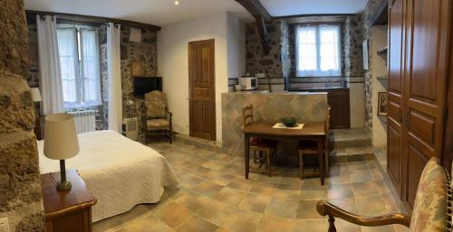 a bedroom with a bed and a table in a room at Etxezuria in Valcarlos