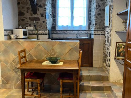 a kitchen with a table with a bowl on it at Etxezuria in Valcarlos