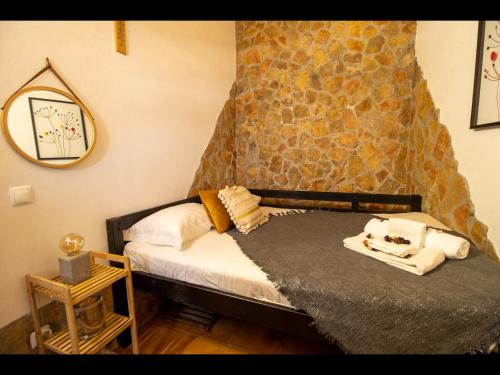 a bedroom with a bed and a stone wall at 2 bedrooms house at Aljezur 100 m away from the beach with sea view furnished terrace and wifi in Aljezur