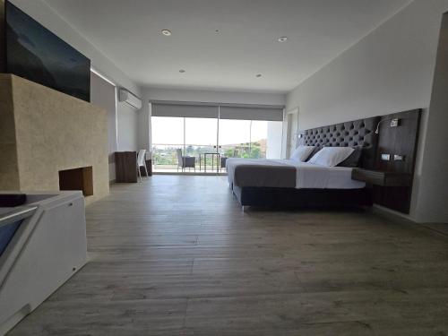 a large bedroom with a bed and a large window at Silver Inn Hotel in Cerro Azul