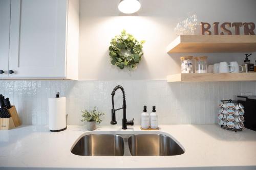 a kitchen sink with a faucet on a counter at Modern Boho Bungalow - Near MOA in Saint Paul