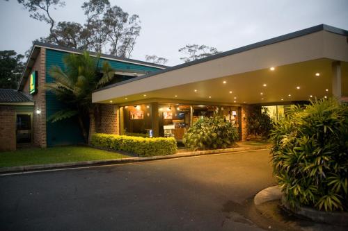 a house with a lit up facade at night at The Select Inn Gosford in Gosford