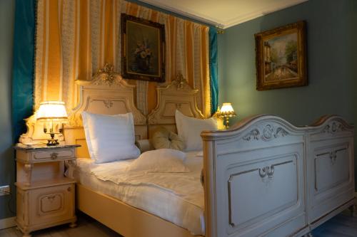 a bedroom with a white bed with a canopy at CASA IANUȘ in Breaza