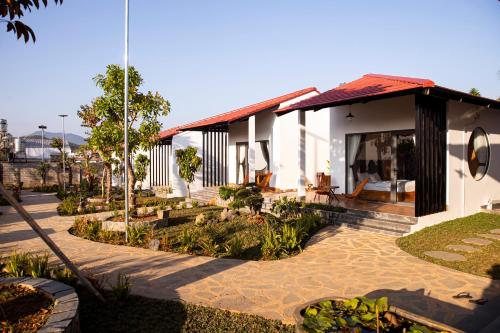 a house with a walkway next to a building at Bảo Lộc Home in Bao Loc