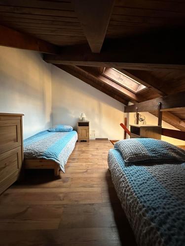 a bedroom with two beds and a wooden floor at Apartma Popeye in Bovec
