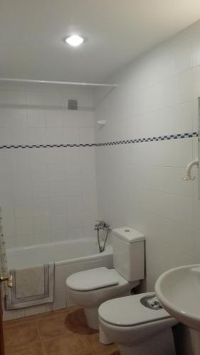 a bathroom with a toilet and a sink at Kione Vidalmar in Alcossebre