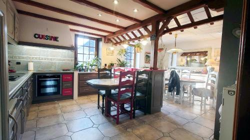 a kitchen with a table and a dining room at Maison Villabella in Butten