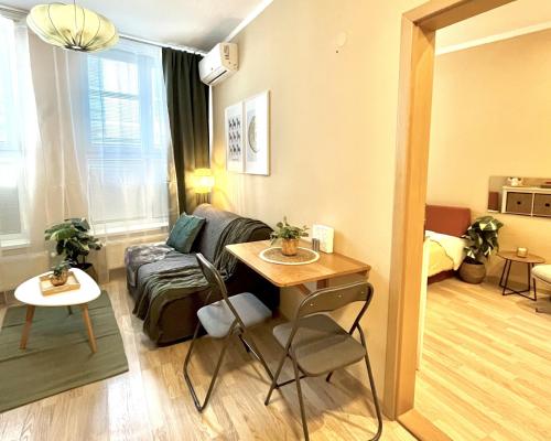 a living room with a couch and a table at Apartment Jenny - Old Town, Free Private Parking, AC in Bratislava