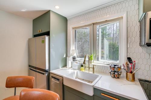 a kitchen with a sink and a refrigerator at Saugerties Farmhouse with Patio and Countryside Views! in Saugerties