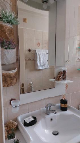 a bathroom with a sink and a mirror and towels at House by the sea/Σπίτι στην θάλασσα in Flámbouras