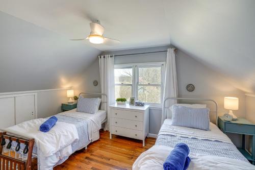 two beds in a room with a window at Saugerties Farmhouse with Patio and Countryside Views! in Saugerties