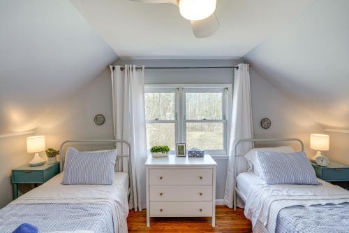 two beds in a room with a window at Saugerties Farmhouse Sauna and Countryside Views in Saugerties