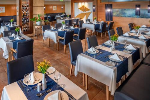 a dining room with blue tables and chairs at Serhs Natal Grand Hotel & Resort in Natal