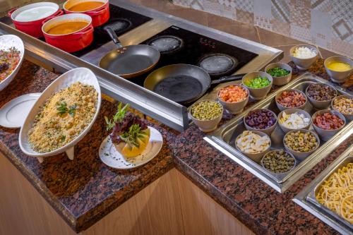 a buffet with different dishes of food on a counter at Serhs Natal Grand Hotel & Resort in Natal