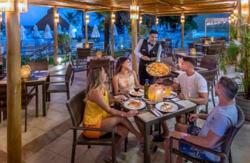 a group of people sitting at a table in a restaurant at Serhs Natal Grand Hotel & Resort in Natal