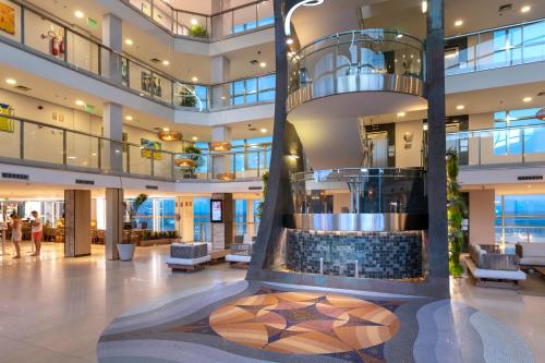 a lobby with a fountain in the middle of a building at Serhs Natal Grand Hotel & Resort in Natal