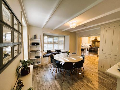 a kitchen and dining room with a table and chairs at Middle Lodge in Ryde