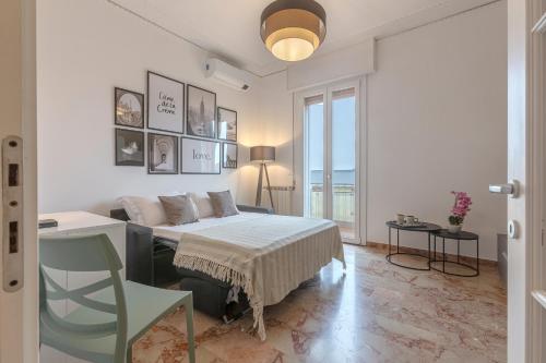 a white bedroom with a bed and a window at Ferrara Il Castello Dazzling Apartment in Ferrara
