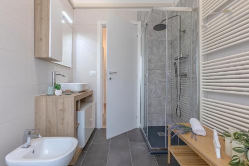 a bathroom with a sink and a shower at Ferrara Il Castello Dazzling Apartment in Ferrara