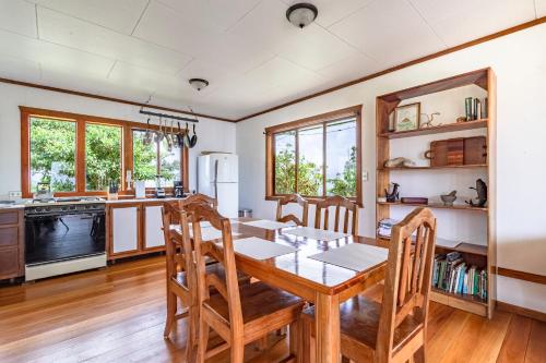 cocina y comedor con mesa de madera y sillas en Refugio San Antonio - 1500 acre Private Preserve, en Guaria