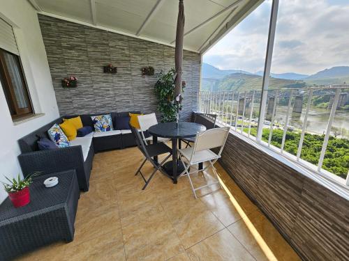 a living room with a table and a couch at Vistadouro in Peso da Régua