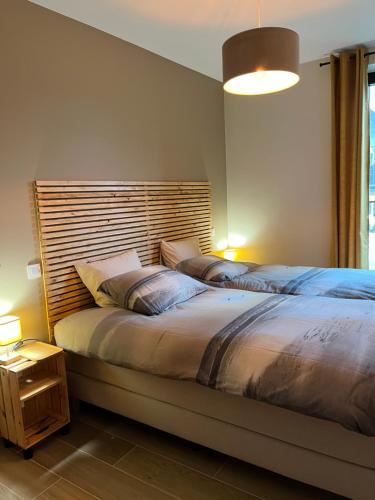 a bedroom with two beds and a large window at Logies La Parmentière in De Panne