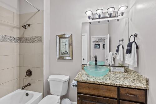 a bathroom with a sink and a tub and a toilet at Sand Hollow 3334 BBQ Grill, Private Splash Pad, Hot tub and Pool in Hurricane