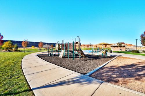a playground in a park with a slide at Sand Hollow 3334 BBQ Grill, Private Splash Pad, Hot tub and Pool in Hurricane