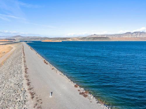 a road in the middle of a body of water at Sand Hollow 3334 BBQ Grill, Private Splash Pad, Hot tub and Pool in Hurricane