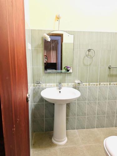 a bathroom with a sink and a mirror at THE NIGHT SHADE B01 in Negombo