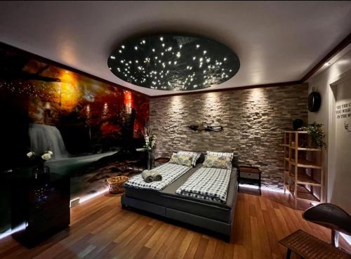 a bedroom with a bed and a brick wall at Barneys Rooms in Hundige