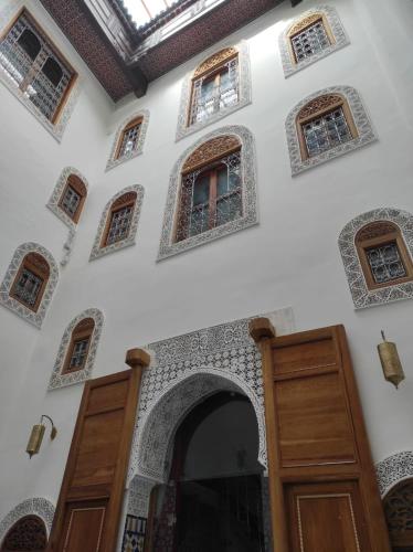 a building with a bunch of windows and doors at Riad Averroès in Fez