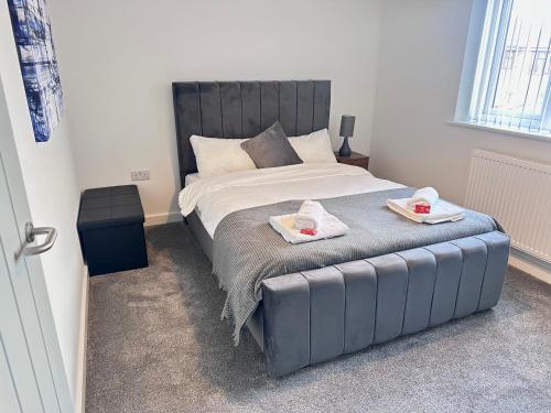 a bedroom with a bed with two towels on it at All Inn Apartments in Staveley