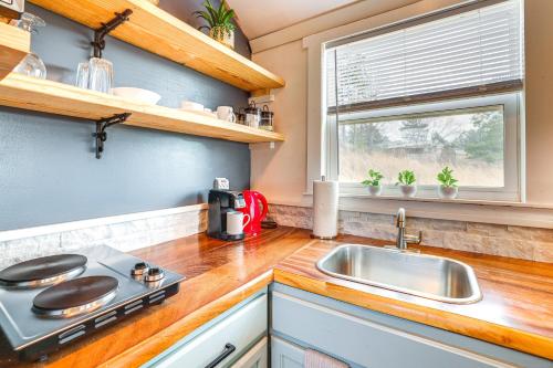 a kitchen with a sink and a stove at Cozy Decatur Cabin with Views about 1 Mi to Riverfront! in Decatur