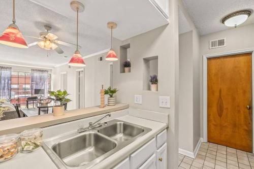 a kitchen with a sink and a counter top at Downtown Columbia Apartment in Columbia