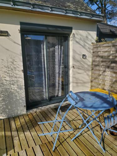 a blue folding chair sitting on a deck at Studio au calme, dans village tranquille in Séné